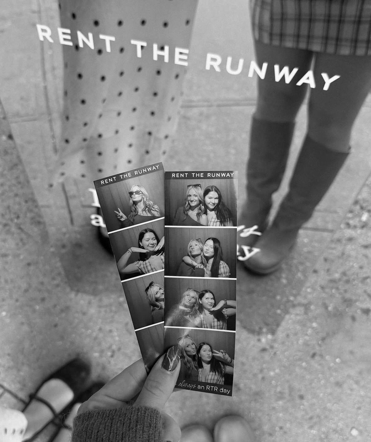 Rent the Runway photo strips held up on the sidewalk